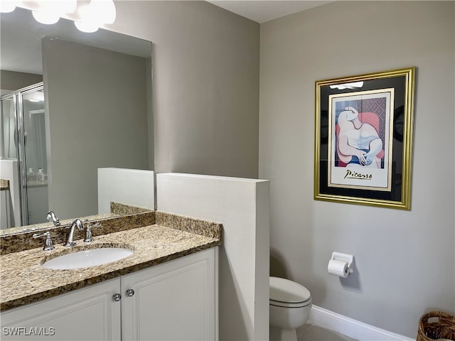 bathroom with vanity, toilet, and tile patterned flooring