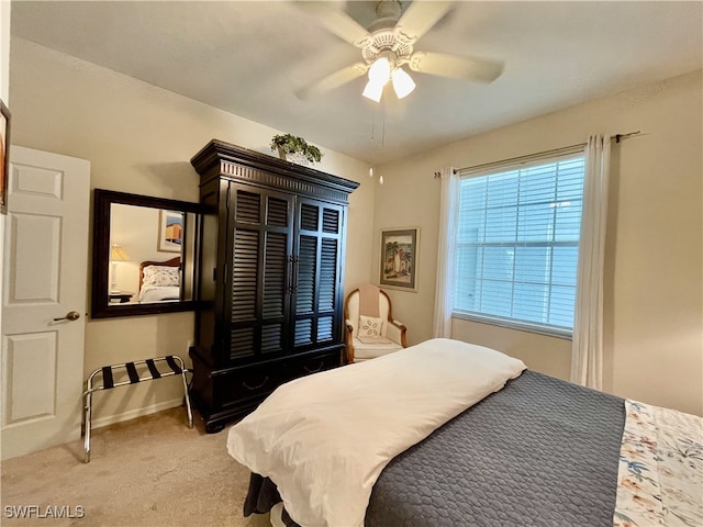 bedroom with light carpet and ceiling fan