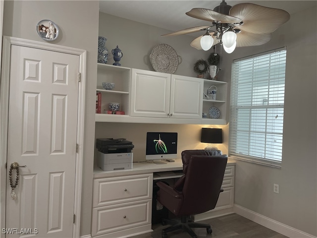 office area with built in desk, ceiling fan, and wood-type flooring