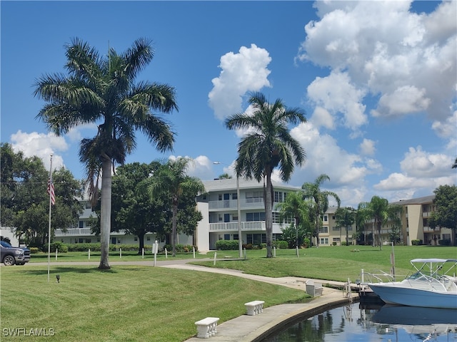 view of community with a water view and a lawn