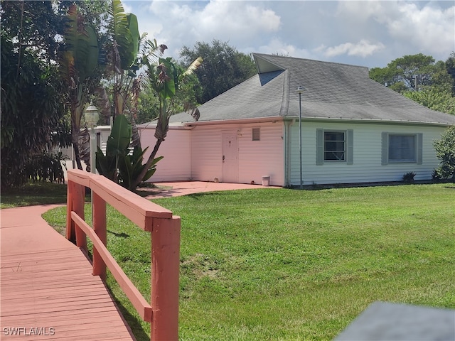 view of side of home with a lawn