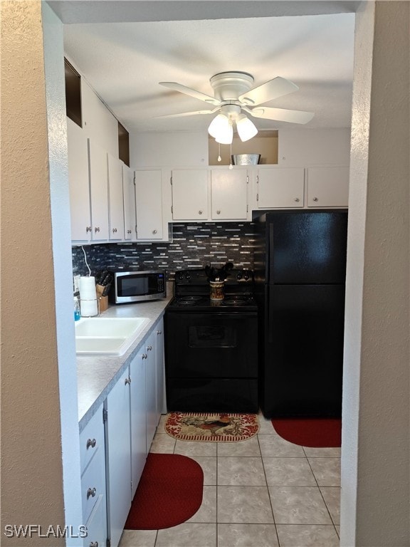 kitchen featuring decorative backsplash, sink, black appliances, white cabinets, and ceiling fan