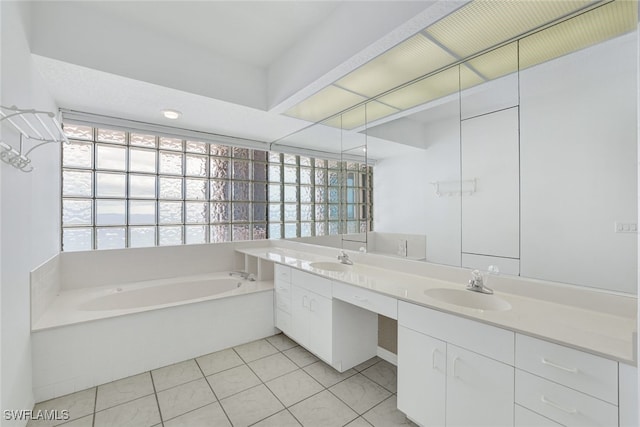 bathroom with a tub to relax in, a healthy amount of sunlight, vanity, and tile patterned floors