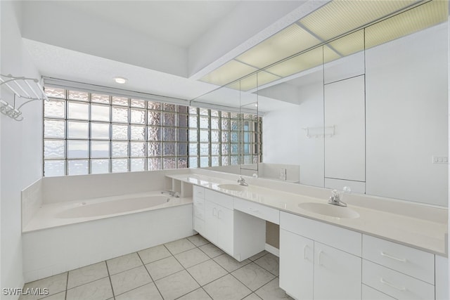 bathroom featuring a bath, tile patterned floors, double vanity, and a sink