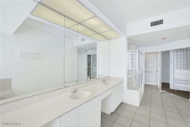 bathroom with vanity, plus walk in shower, and tile patterned flooring