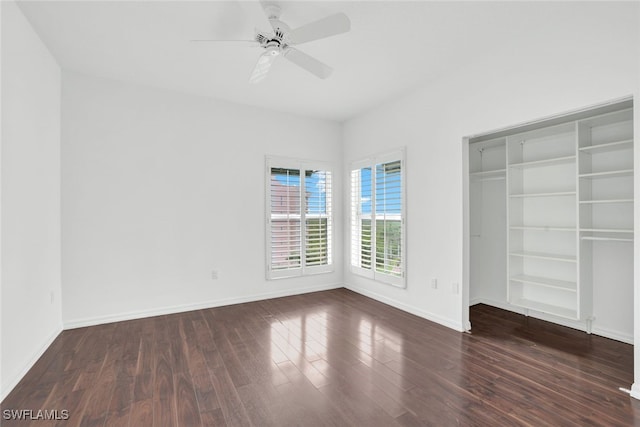 unfurnished bedroom with ceiling fan, baseboards, and wood finished floors