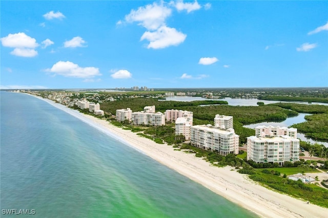 birds eye view of property with a view of city, a beach view, and a water view