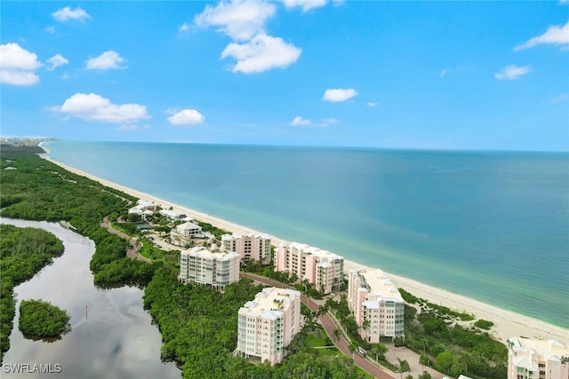 drone / aerial view featuring a view of the beach, a view of city, and a water view