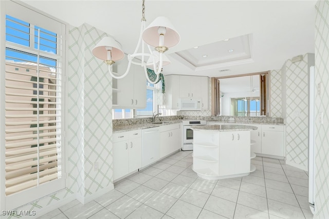 kitchen featuring open shelves, a sink, white appliances, wallpapered walls, and a raised ceiling