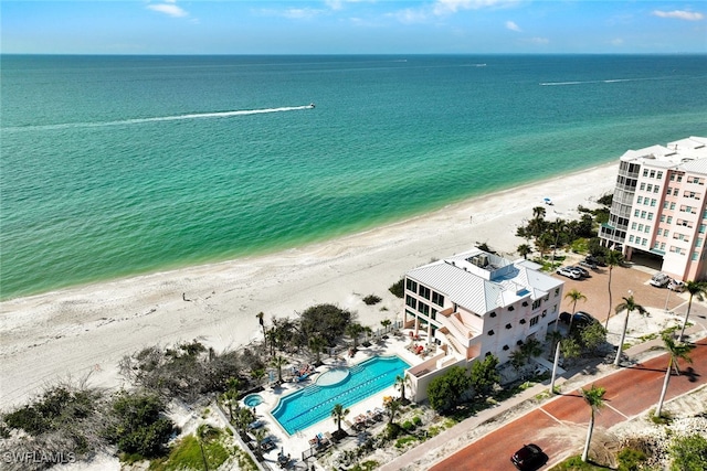 bird's eye view featuring a water view and a beach view