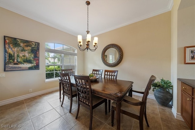 dining space featuring tile patterned floors, crown molding, and a chandelier