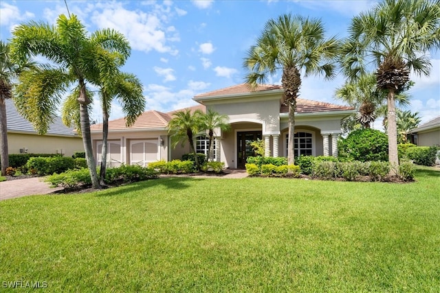 mediterranean / spanish home with a front lawn