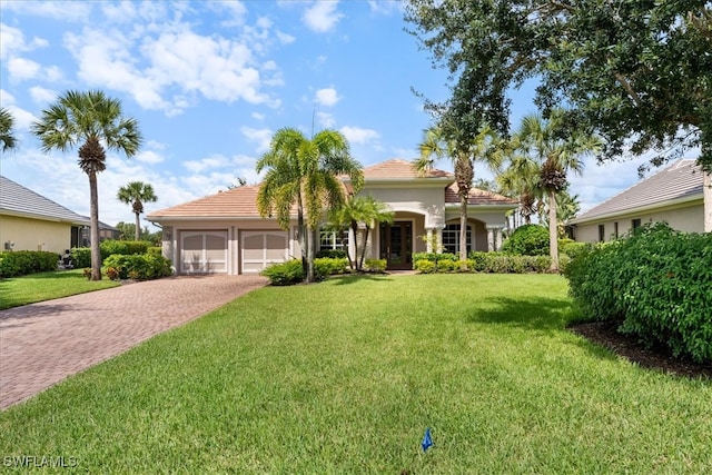 view of front of property featuring a garage and a front lawn