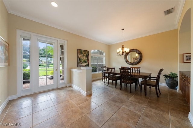 dining area featuring crown molding and a notable chandelier