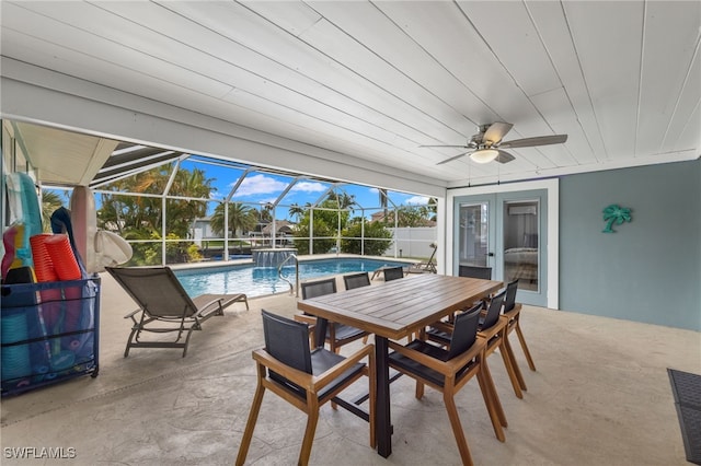 sunroom / solarium with a swimming pool, ceiling fan, and wood ceiling