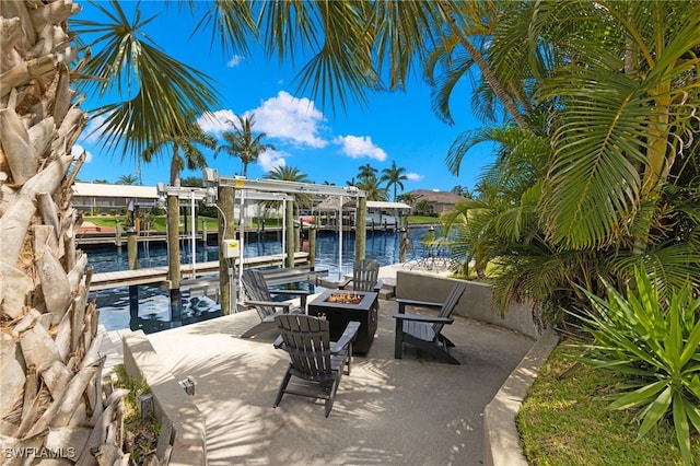 dock area featuring a fire pit and a water view