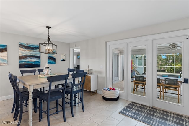 dining space with light tile patterned flooring and an inviting chandelier