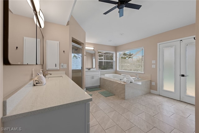 bathroom with ceiling fan, separate shower and tub, vanity, and tile patterned floors