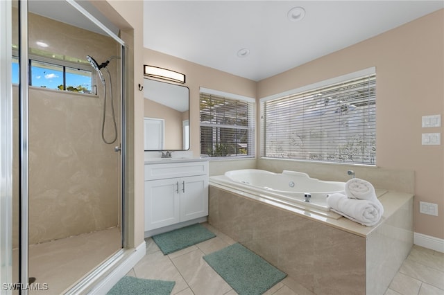 bathroom featuring vanity, vaulted ceiling, tile patterned floors, and shower with separate bathtub