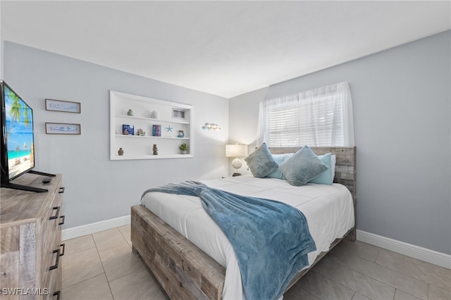 bedroom featuring light tile patterned flooring