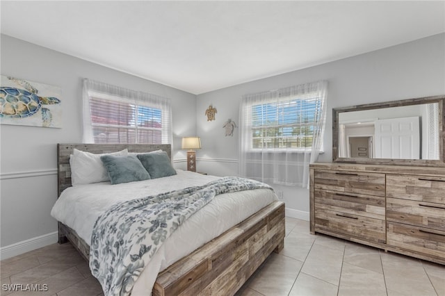 bedroom featuring multiple windows and light tile patterned floors