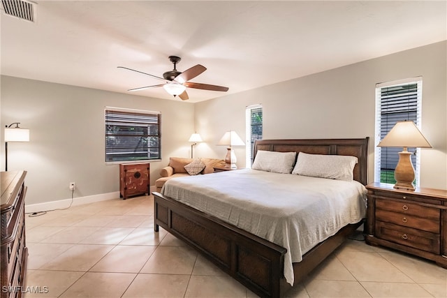 tiled bedroom featuring ceiling fan