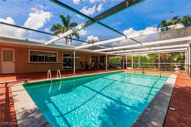 view of pool featuring a lanai and a patio