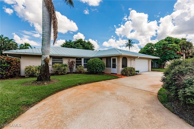 ranch-style home featuring a garage and a front yard