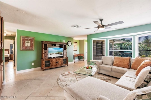 living room featuring light tile patterned floors and ceiling fan