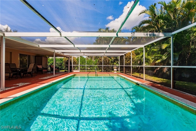 view of pool with a patio and a lanai