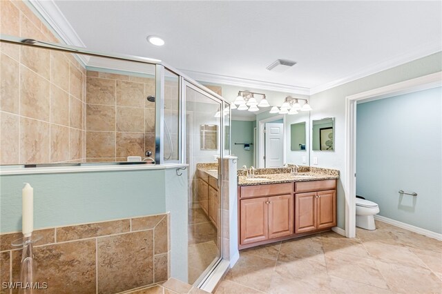 bathroom featuring crown molding, a shower with door, vanity, and toilet