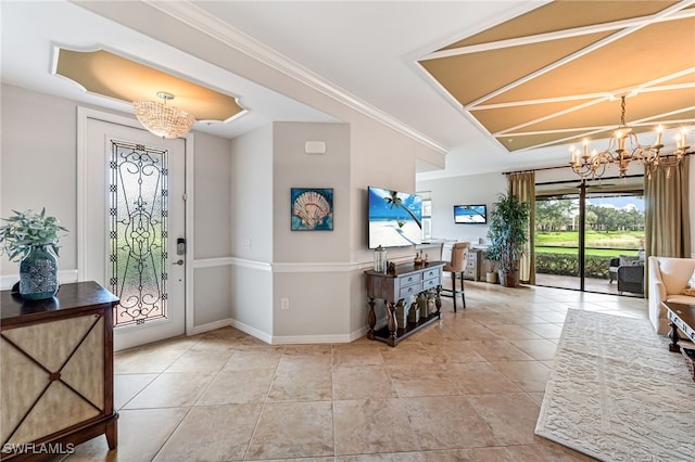 entryway with a notable chandelier, crown molding, and light tile patterned floors