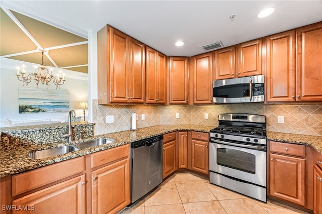 kitchen with light tile patterned flooring, tasteful backsplash, a notable chandelier, appliances with stainless steel finishes, and stone countertops