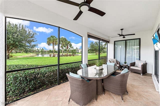 sunroom featuring ceiling fan