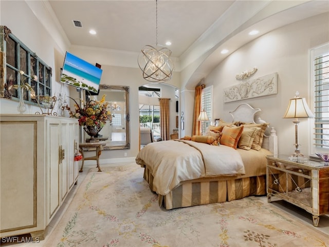 bedroom featuring ornamental molding and a notable chandelier