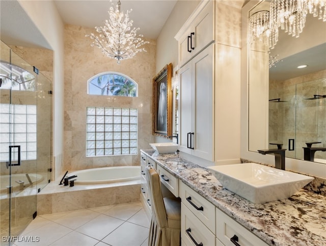 bathroom with a notable chandelier, tile patterned flooring, vanity, and independent shower and bath