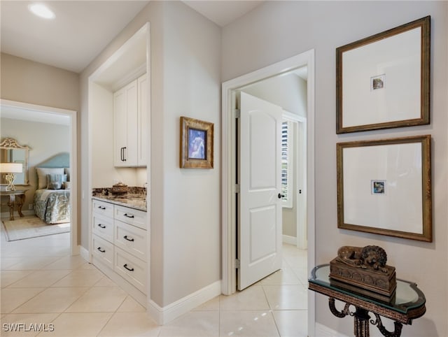 hall featuring light tile patterned floors