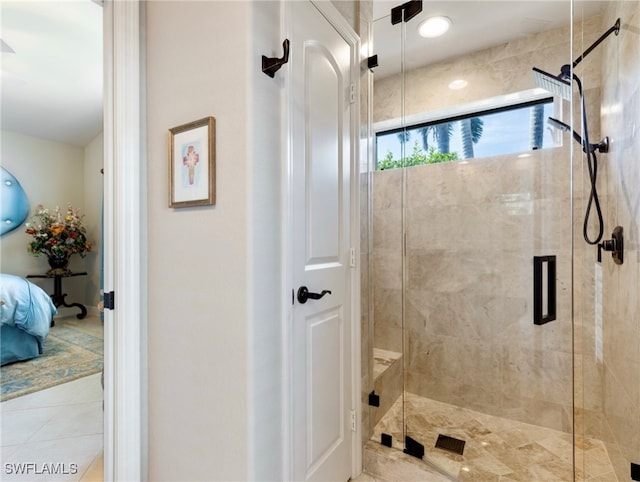 bathroom featuring tile patterned floors and a shower with shower door