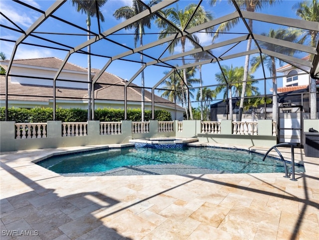 view of swimming pool with an in ground hot tub, glass enclosure, and a patio