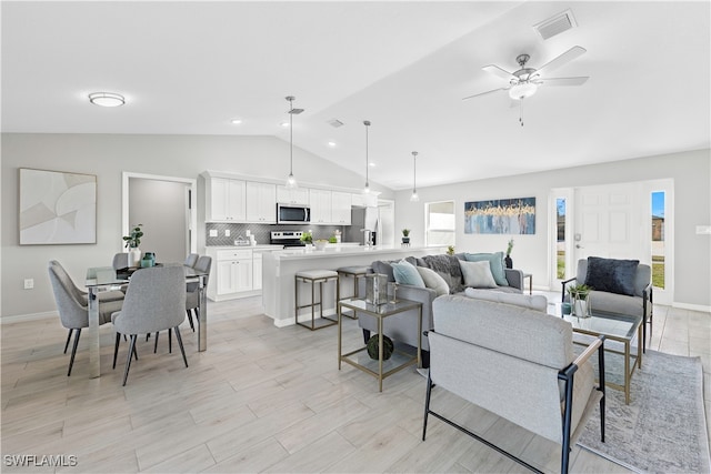 living room featuring vaulted ceiling and ceiling fan