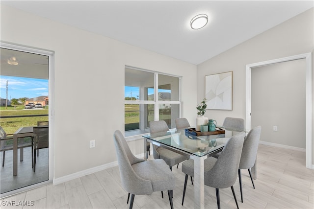 dining room featuring lofted ceiling