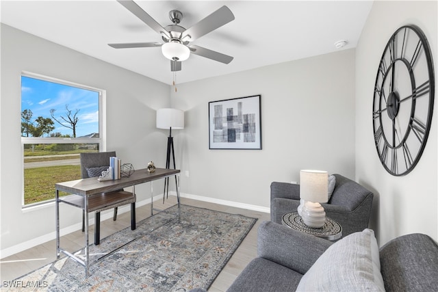 office space featuring light wood-type flooring and ceiling fan