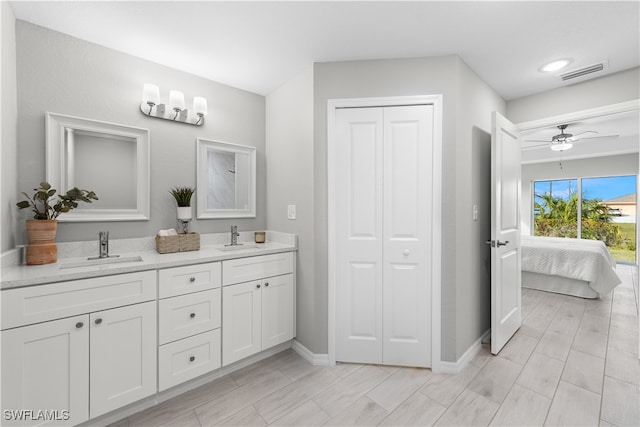 bathroom featuring ceiling fan and vanity