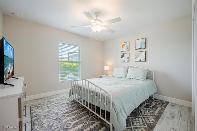 bedroom featuring hardwood / wood-style flooring and ceiling fan