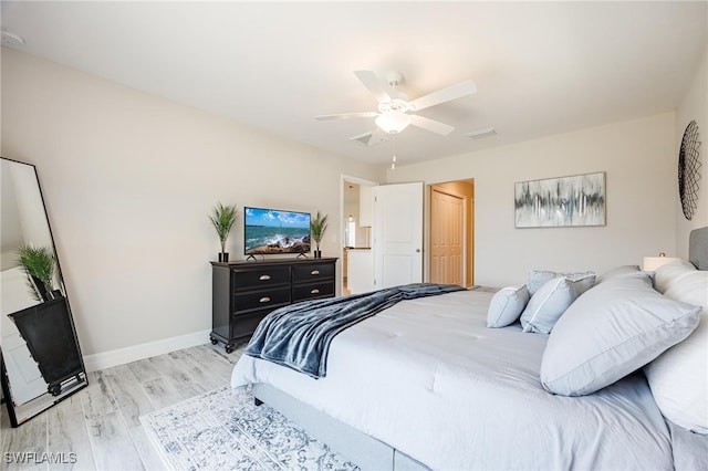 bedroom featuring ceiling fan, light wood-type flooring, and a closet