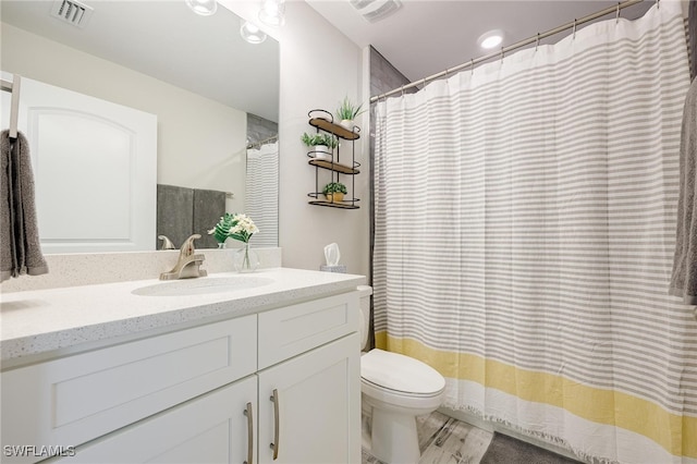 bathroom featuring hardwood / wood-style floors, vanity, and toilet