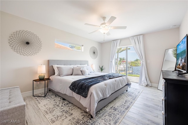 bedroom featuring access to outside, ceiling fan, and light hardwood / wood-style floors