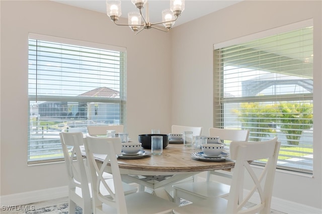 dining space featuring a healthy amount of sunlight and a notable chandelier