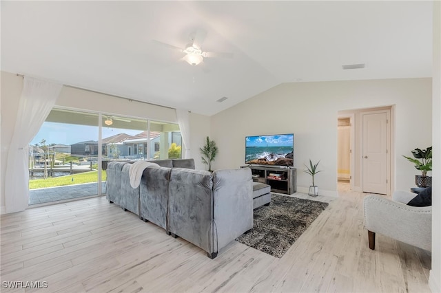 living room with light hardwood / wood-style flooring, ceiling fan, and lofted ceiling