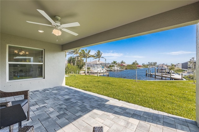 view of patio featuring a boat dock, a water view, and ceiling fan